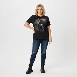 May include: A black t-shirt featuring a graphic of a person with pink hair and angel wings. The person is wearing a black leather jacket. The model is wearing dark blue jeans and black boots.