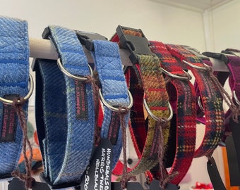 May include: Assortment of colorful dog collars made of tweed fabric with metal buckles and D-rings. The collars are displayed on a rack with price tags.