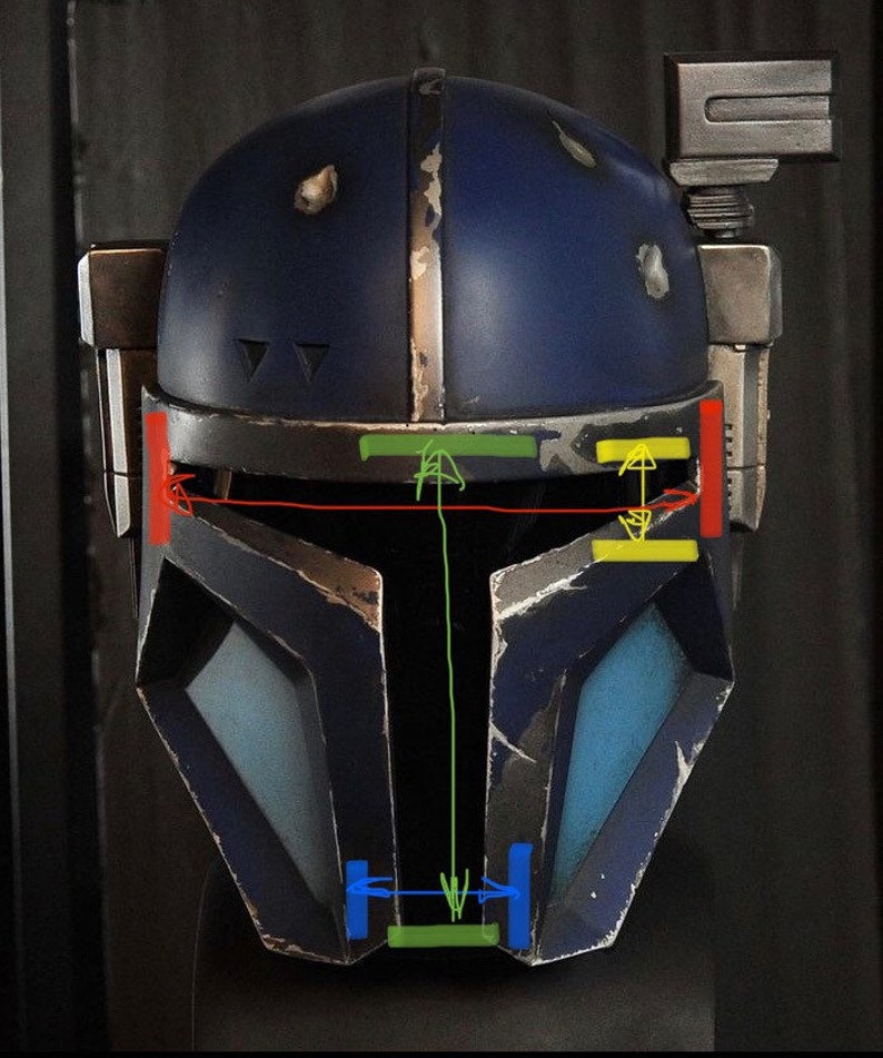 May include: A blue and gray helmet with a visor and a weathered look. The helmet has a rectangular panel on the top and a small rectangular panel on the side. The helmet has a green, yellow, and red stripe across the top.