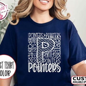 May include: Navy blue t-shirt with the word "Pointers" in a white, stylized design. The letter "P" is prominent, with a star and stripe pattern. The shirt also features the text "Select T-Shirt Color" and "Custom Available Upon Request".