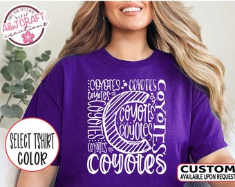 May include: Purple t-shirt with a white graphic design that says "Coyotes" multiple times in a circular pattern. The design features a stylized letter "C" with stripes.