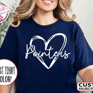 May include: Navy blue t-shirt with a white heart design and the word "Pointers" in a cursive font. The shirt also features the text "SELECT TSHIRT COLOR" and "CUSTOM AVAILABLE UPON REQUEST".