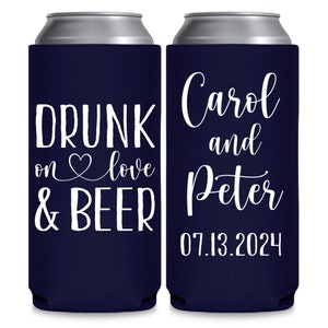 May include: Two navy blue can coolers with white text. The cooler on the left says 'Drunk on love & beer'. The cooler on the right says 'Carol and Peter 07.13.2024'.