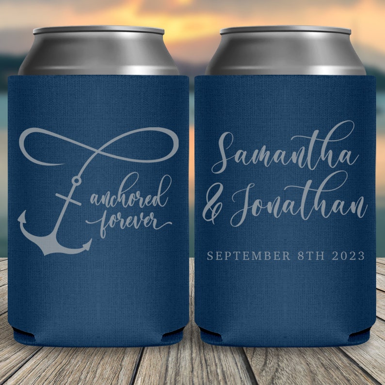 May include: Two blue can coolers with white text. The cooler on the left has an anchor and infinity symbol with the text 'anchored forever'. The cooler on the right has the text 'Samantha & Jonathan SEPTEMBER 8TH 2023'.