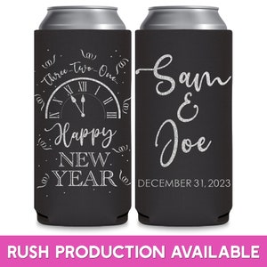 May include: Two black and silver can coolers. The cooler on the left has a clock face with the words 'Three... Two... One... Happy New Year' around it. The cooler on the right has the words 'Sam & Joe' and 'December 31, 2023'.