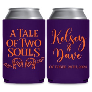 May include: Two purple can coolers with orange text. The left cooler has the text 'A Tale of Two Souls' with a drawing of two tombstones with hearts on them and bats. The right cooler has the text 'Kelsey & Dave' and 'October 28th, 2024'.