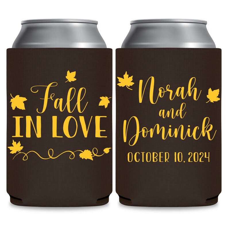 May include: Two brown can coolers with yellow text and leaf designs. The left cooler says 'Fall in Love' with a swirl design and leaves. The right cooler says 'Norah and Dominick' with a date of 'October 10, 2024'.