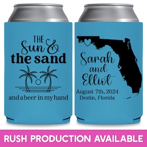 May include: Two blue and white can coolers. The left cooler has palm trees and the text 'THE Sun & the sand and a beer in my hand'. The right cooler has a black outline of the state of Florida with a heart in the panhandle and the text 'Sarah and Elliot August 7th, 2024 Destin, Florida'. The text 'RUSH PRODUCTION AVAILABLE' is at the bottom of the image.