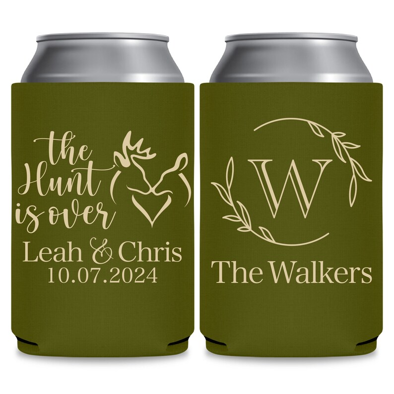 May include: Two green can coolers with white text. The cooler on the left has a deer silhouette and the text 'The Hunt is Over Leah & Chris 10.07.2024'. The cooler on the right has a wreath with the letter 'W' in the center and the text 'The Walkers'.