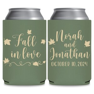 May include: Two green can coolers with a fall wedding theme. The left cooler has the text 'Fall in love' with a vine and leaves design. The right cooler has the text 'Norah and Jonathan' and the date 'OCTOBER 10, 2024'.