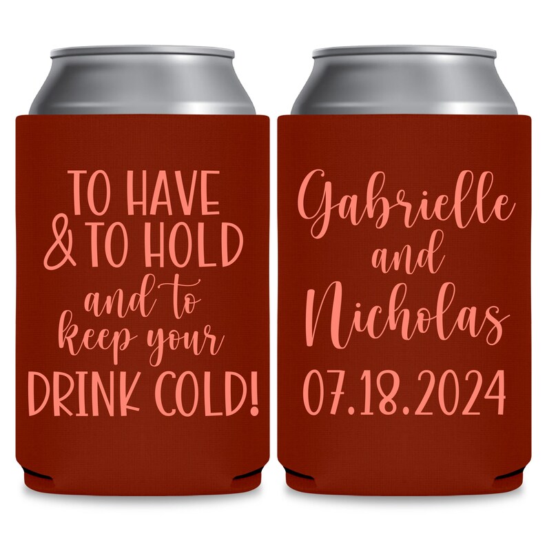 May include: Two red can coolers with white text. The left cooler says 'TO HAVE & TO HOLD and to keep your DRINK COLD!' The right cooler says 'Gabrielle and Nicholas 07.18.2024'.