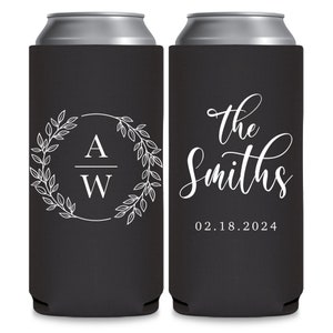 May include: Two black can coolers with white text. The cooler on the left has a wreath with the letters A and W inside. The cooler on the right has the text 'the Smiths' and '02.18.2024'.