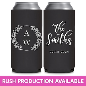 May include: Two black can coolers with white text. The cooler on the left has a wreath with the letters 'A' and 'W' inside. The cooler on the right has the text 'the Smiths' and '02.18.2024'.
