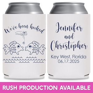 May include: Two white can coolers with blue text. The left cooler has two fish kissing with a fishing line and a bobber above them. The text reads 'We've been hooked'. The right cooler has the text 'Jennifer and Christopher Key West, Florida 06.17.2025'. 