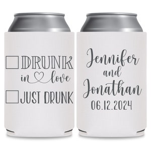 May include: Two white can coolers with gray text. The cooler on the left has a checkbox next to the text 'DRUNK in love' and another checkbox next to the text 'JUST DRUNK'. The cooler on the right has the text 'Jennifer and Jonathan 06.12.2024'.