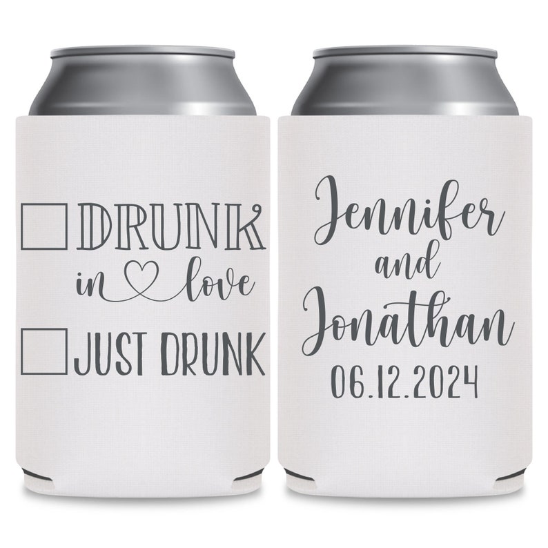 May include: Two white can coolers with gray text. The cooler on the left has a checkbox next to the text 'DRUNK in love' and another checkbox next to the text 'JUST DRUNK'. The cooler on the right has the text 'Jennifer and Jonathan 06.12.2024'.