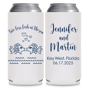 May include: Two white can coolers with blue text and graphics. The left cooler has two fish kissing with hearts above them and the text 'two less fish in the sea'. The right cooler has the text 'Jennifer and Martin Key West, Florida 06.17.2025'.