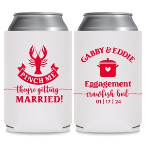 May include: Two white can coolers with red text and graphics. The cooler on the left has a red crawfish with the text 'Pinch Me' and 'They're getting married!' The cooler on the right has the text 'Gabby & Eddie' and 'Engagement crawfish boil 01|17|24' with a red pot and heart graphic.