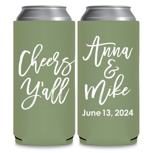 May include: Two green can coolers with white text. The left cooler says 'Cheers y'all' and the right cooler says 'Anna & Mike June 13, 2024'.