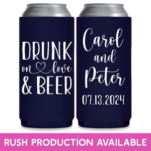 May include: Two navy blue can coolers with white text. The left cooler says 'Drunk on love & beer'. The right cooler says 'Carol and Peter 07.13.2024'.