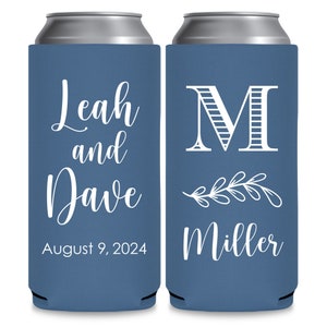 May include: Two blue can coolers with white text. The left cooler has the text 'Leah and Dave August 9, 2024'. The right cooler has the text 'M Miller' with a stylized floral design.