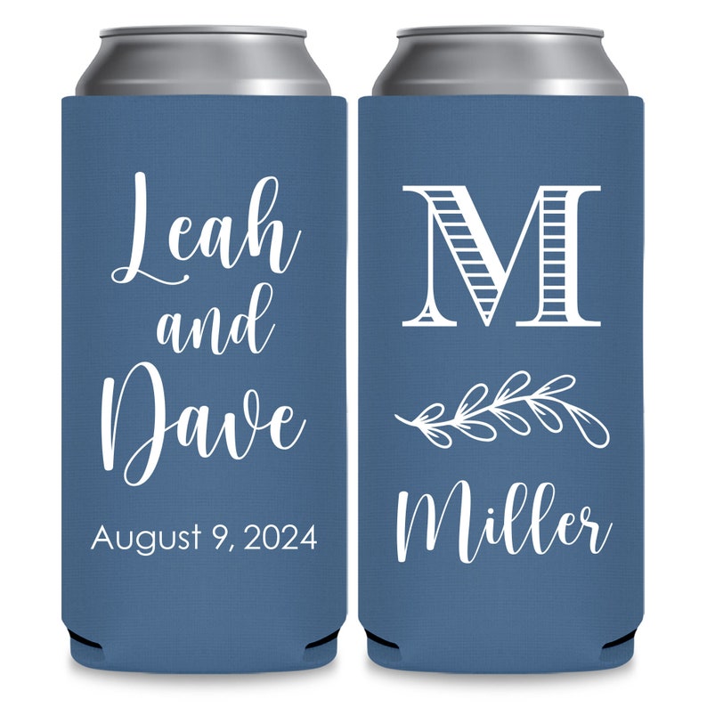 May include: Two blue can coolers with white text. The left cooler has the text 'Leah and Dave August 9, 2024'. The right cooler has the text 'M Miller' with a stylized floral design.