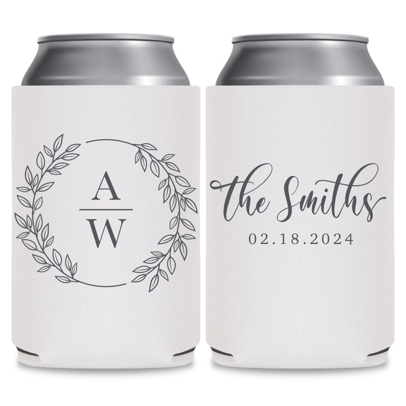 May include: Two white can coolers with a gray design. The cooler on the left has a wreath with leaves and the initials 'A W' inside. The cooler on the right has the text 'The Smiths' in cursive and the date '02.18.2024'.
