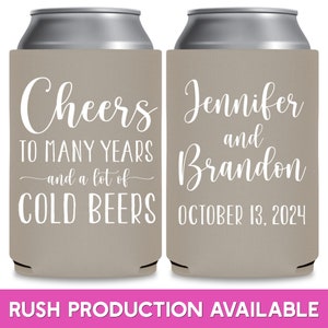 May include: Two brown and white can coolers. The left cooler has the text 'Cheers to many years and a lot of cold beers'. The right cooler has the text 'Jennifer and Brandon October 13, 2024'.