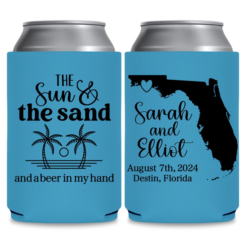 May include: Two blue and white can coolers. The left cooler has palm trees and the text 'THE Sun & the sand and a beer in my hand'. The right cooler has a black outline of the state of Florida with a heart in the panhandle and the text 'Sarah and Elliot August 7th, 2024 Destin, Florida'.