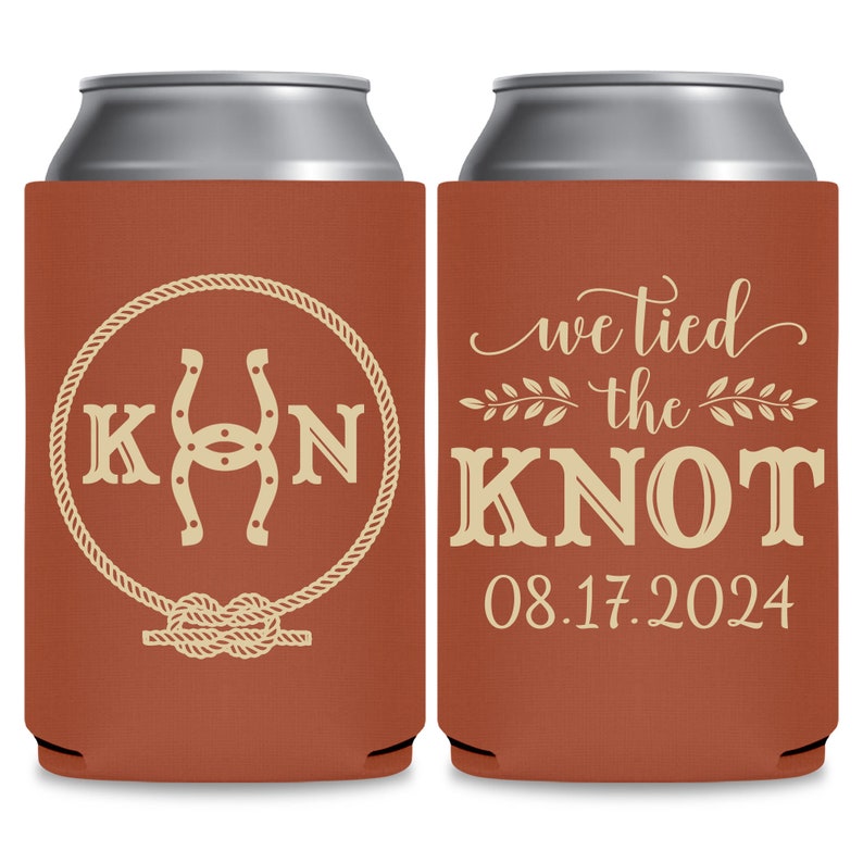 May include: Two brown and beige can coolers. The left cooler has a horseshoe and the letters K and N in a circle with a rope design. The right cooler has the text 'we tied the knot' with a floral design and the date '08.17.2024'.