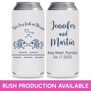 May include: Two white can coolers with blue text and illustrations. The left cooler has two fish kissing with hearts above them and the text 'two less fish in the sea'. The right cooler has the text 'Jennifer and Martin Key West, Florida 06.17.2025'. Both coolers have a silver top.