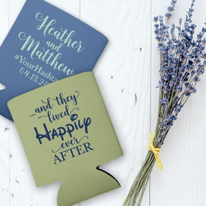 May include: Two koozies, one blue and one green. The blue koozie has the text 'Heather and Matthew #YourHashtag 04.13.24' on it. The green koozie has the text '...and they lived happily ever after' on it.