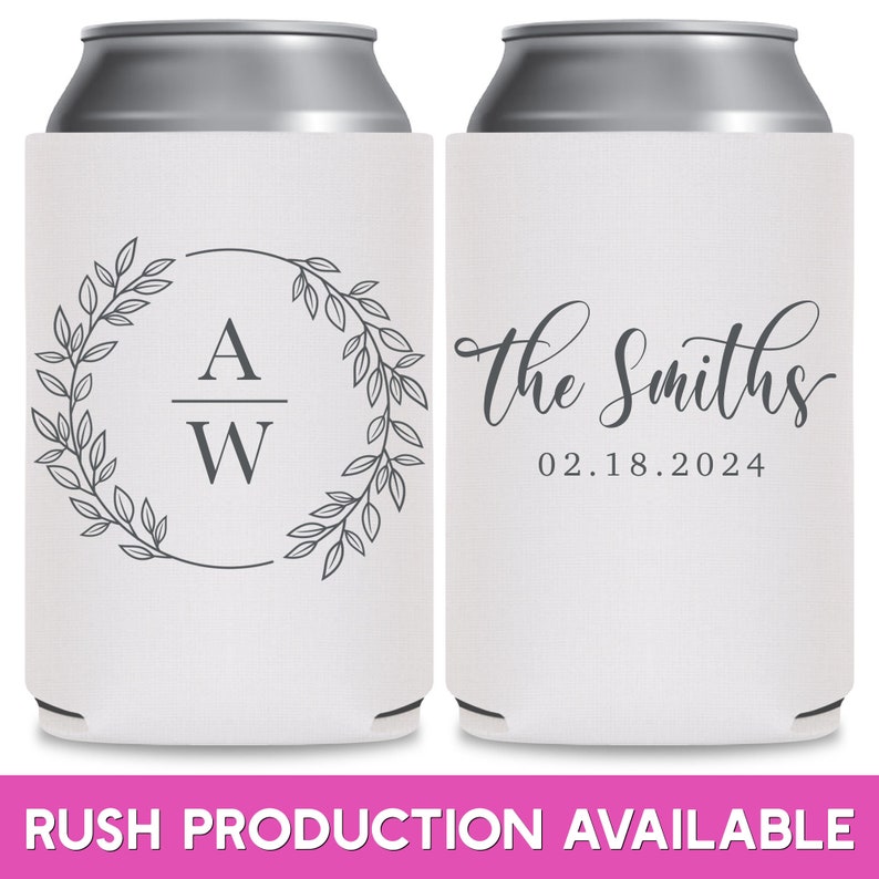 May include: Two white can coolers with a gray design. The cooler on the left has a wreath with leaves and the initials 'A/W' in the center. The cooler on the right has the text 'The Smiths' in cursive writing with the date '02.18.2024' below it.