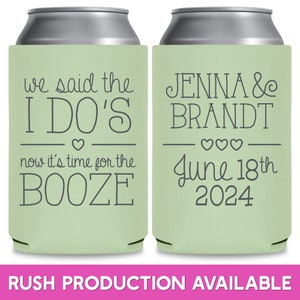 May include: Two green and white can coolers. The left cooler has the text 'we said the I DO'S now it's time for the BOOZE' with a heart symbol. The right cooler has the text 'JENNA & BRANDT June 18th 2024' with three heart symbols.