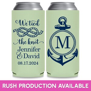May include: Two green can coolers with a nautical theme. The cooler on the left has a rope knot and the text 'We tied the knot Jennifer & David 08.17.2024'. The cooler on the right has an anchor with a rope circle around it and the letter 'M' in the center.