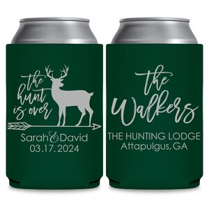 May include: Two green can coolers with white text. The cooler on the left has a white deer silhouette and an arrow with the text 'the hunt is over' and 'Sarah & David 03.17.2024'. The cooler on the right has the text 'the Walkers THE HUNTING LODGE Attapulgus, GA'.