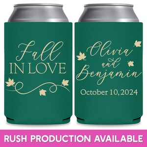 May include: Two green can coolers with white text. The left cooler says 'Fall in Love' with a vine and leaves. The right cooler says 'Olivia and Benjamin' with leaves and 'October 10, 2024'.