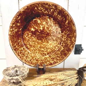 May include: A large round bowl with a mottled brown and cream sponge-painted finish, accompanied by a smaller bowl featuring a black and white transfer-printed landscape pattern, and a bundle of dried wheat stalks tied with a dark ribbon.