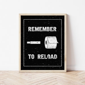 May include: Black and white graphic print with the text "Remember to reload" and a toilet paper roll and a cigarette.