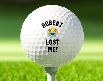 May include: A white golf ball with black text that reads "ROBERT LOST ME!" and a yellow crying emoji.