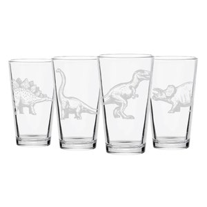 May include: Set of four clear glass drinking glasses with etched dinosaur designs. Each glass features a different dinosaur, including a stegosaurus, a brachiosaurus, a tyrannosaurus rex, and a triceratops.