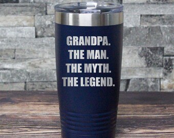May include: A navy blue stainless steel tumbler with a silver lid. The tumbler has the text "GRANDPA. THE MAN. THE MYTH. THE LEGEND." engraved on the front.