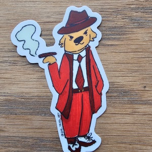May include: A cartoon illustration of a dog wearing a red suit, a brown fedora, and a red tie. The dog is holding a cigar in its mouth and has a cloud of smoke coming out of its mouth. The dog is standing on a white background. The text "@SHE_TRIED_ART" is written on the bottom of the image.