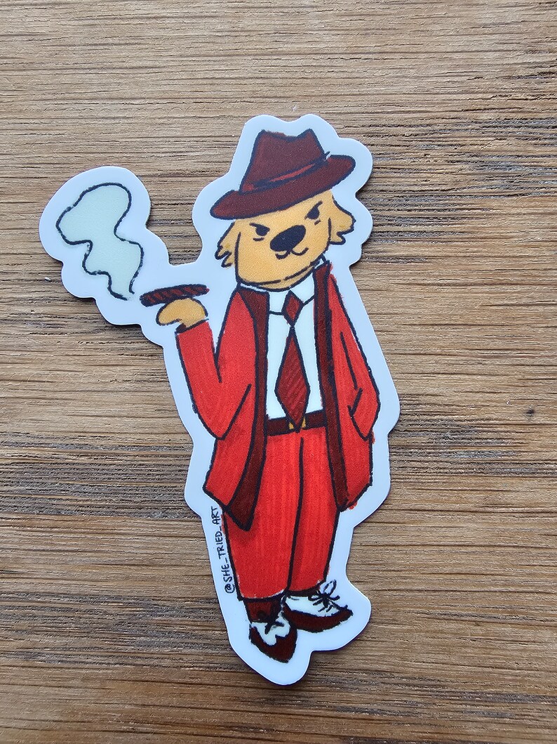 May include: A cartoon illustration of a dog wearing a red suit, a brown fedora, and a red tie. The dog is holding a cigar in its mouth and has a cloud of smoke coming out of its mouth. The dog is standing on a white background. The text "@SHE_TRIED_ART" is written on the bottom of the image.
