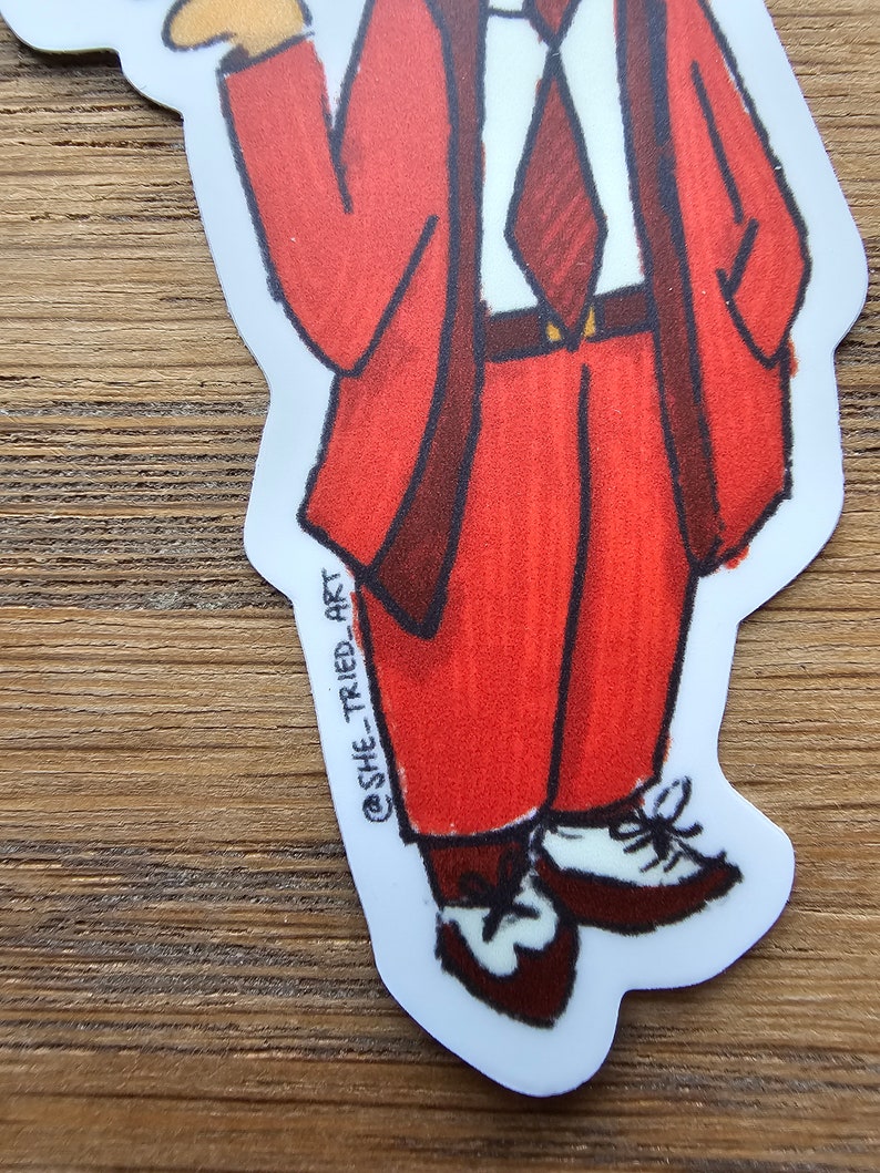 May include: A cartoon illustration of a person wearing a red suit, a white shirt, and a dark red tie. The person is wearing brown shoes with white laces. The illustration is on a white background with the text "@SHE_TRIED_ART" in the lower left corner.