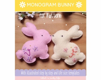 May include: Two felt bunny plushies, one pink and one white, with embroidered flowers and letters. The bunnies are kissing. The text "MONOGRAM BUNNY" and "PDF Pattern" is visible at the top of the image.