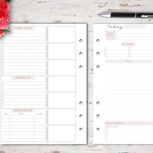 May include: A white planner with a pink and gray design. The left page has sections for goals, to do, shopping list, and expense tracker. The right page has sections for today's focus, to contact, to do, health/exercise, meal plan, schedule, and daily habits.