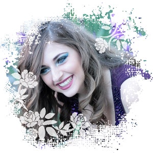 May include: A portrait of a woman with long brown hair smiling. She is wearing a purple top and has blue eye shadow. The background is a white and blue abstract design with white flowers.