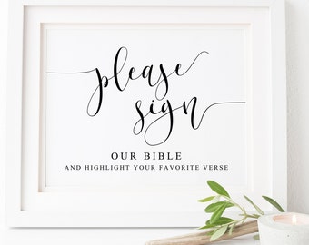 May include: White framed sign with black calligraphy that says "Please sign our bible and highlight your favorite verse".