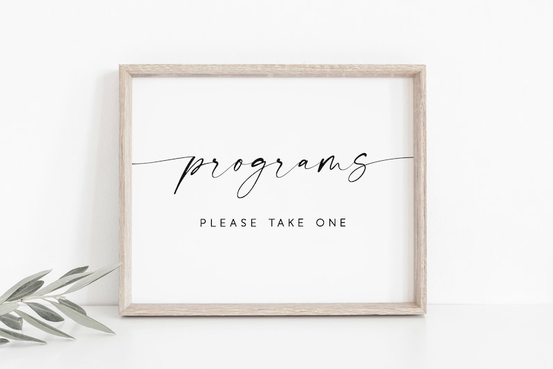 May include: A framed sign with the text "programs" in a cursive font and the text "please take one" in a sans-serif font.